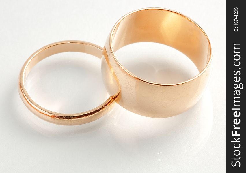 Closeup view of two gold rings with different sizes