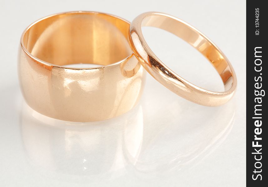 Closeup view of two gold rings with different sizes