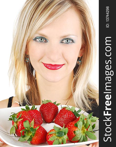 Beautiful blond girl with red lips with a plate fresh strawberry. Portrait studio shoot. Beautiful blond girl with red lips with a plate fresh strawberry. Portrait studio shoot.