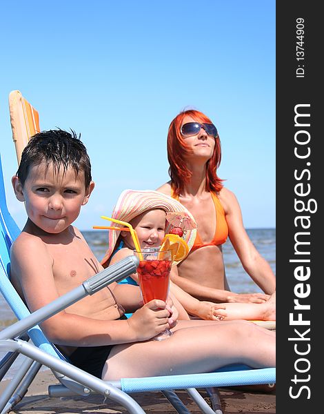 Young family relaxing on beach (boy in focus)