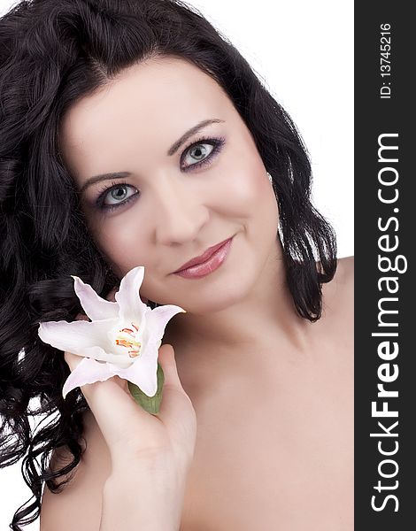 Beautiful woman with a lily flower on a white background. Beautiful woman with a lily flower on a white background