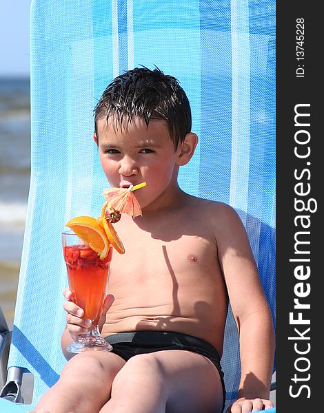 Cute little boy relaxing on the beach. Cute little boy relaxing on the beach