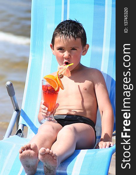 Cute little boy relaxing on the beach. Cute little boy relaxing on the beach