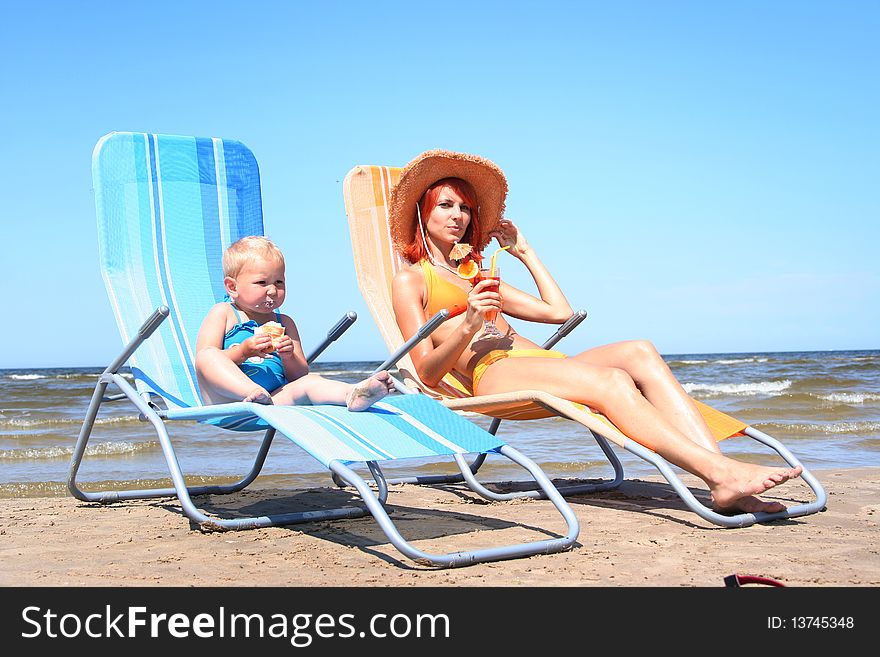 Young mother with little daugher on the beach. Young mother with little daugher on the beach