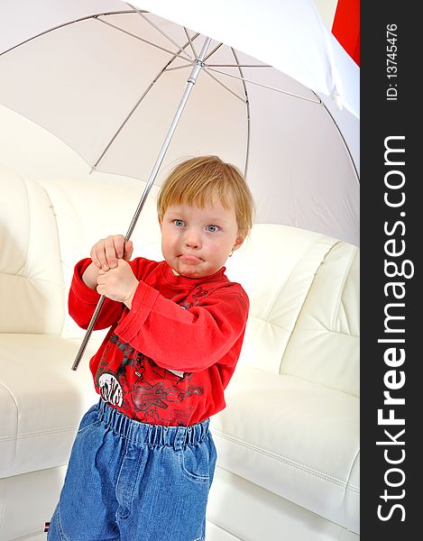 Child is making a face with umbrella. Child is making a face with umbrella