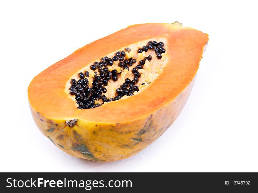 Closed-up half of papaya isolated on white