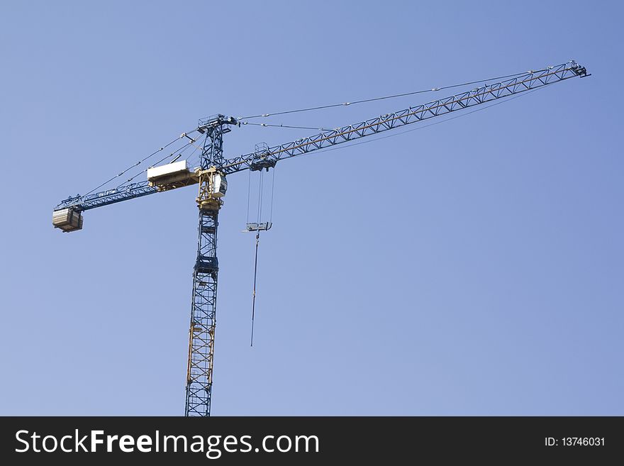 Buildng crane on blue sky background