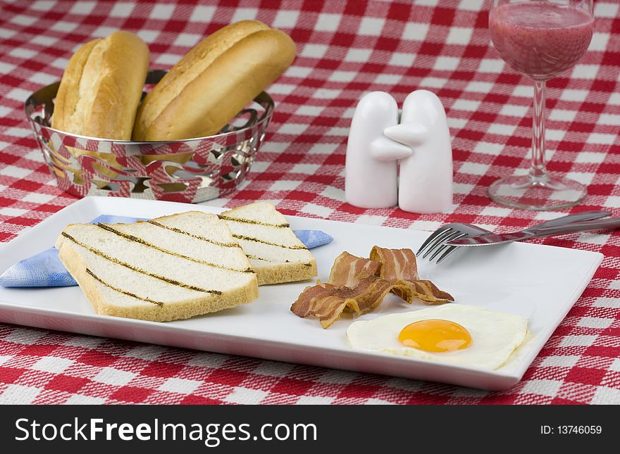 Hearty breakfast with toast, bacon and egg.