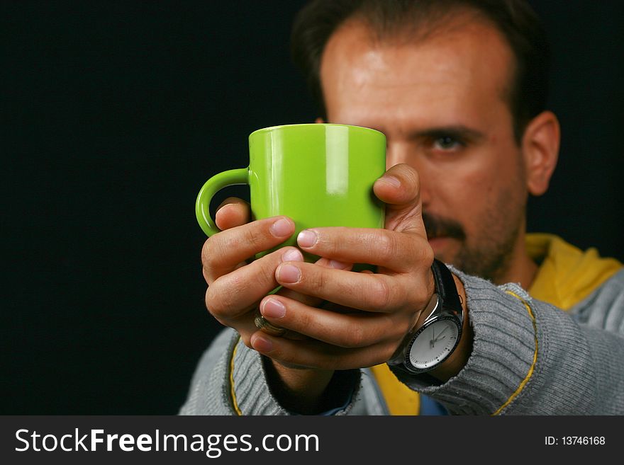 An image of a charismatic man drinking tea. An image of a charismatic man drinking tea