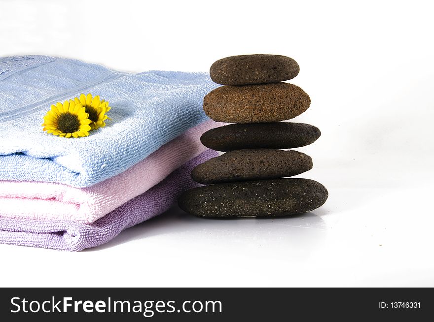 Candles, towel, massage stones and flowers. Candles, towel, massage stones and flowers