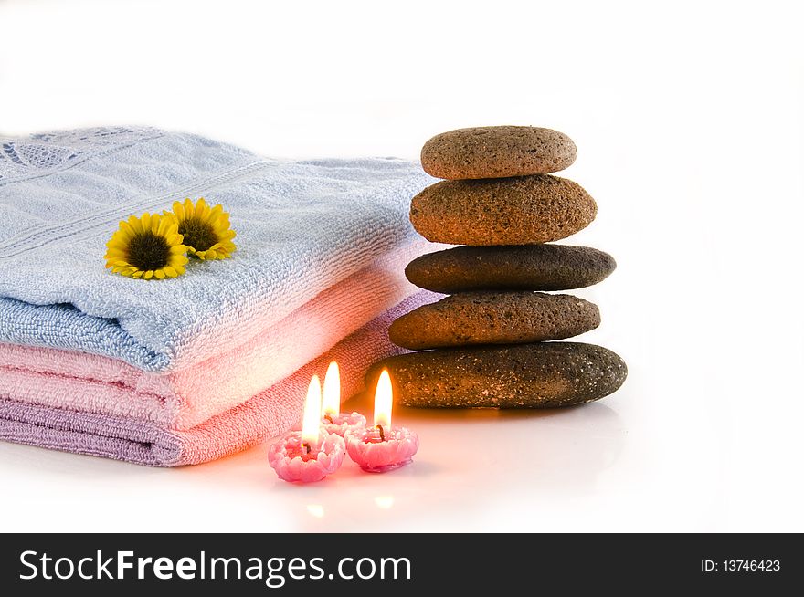 Candles, towel, massage stones and flowers. Candles, towel, massage stones and flowers