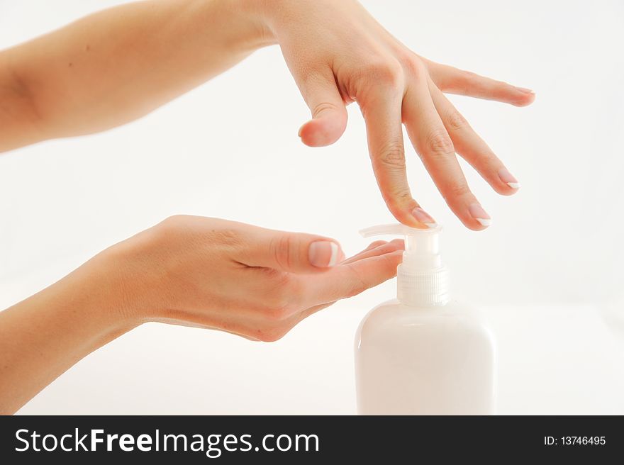 Women hand pressing soap dispencer in white background. Women hand pressing soap dispencer in white background