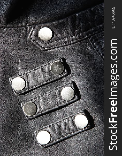The details of a black leather jacket。Very nice metal button。
