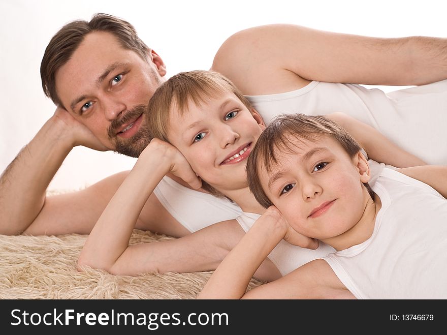 Father with his two sons on the carpet. Father with his two sons on the carpet