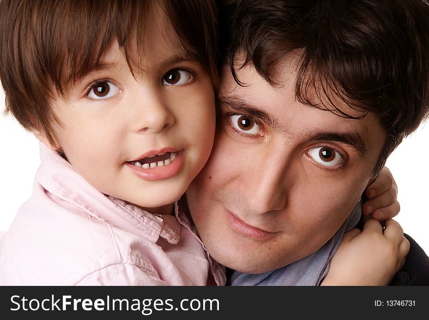 Little beautiful smiling boy hugs his young attractive father on white background. Little beautiful smiling boy hugs his young attractive father on white background