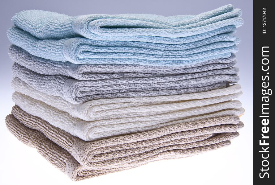 Neutral colored bath towels made of terry cloth.