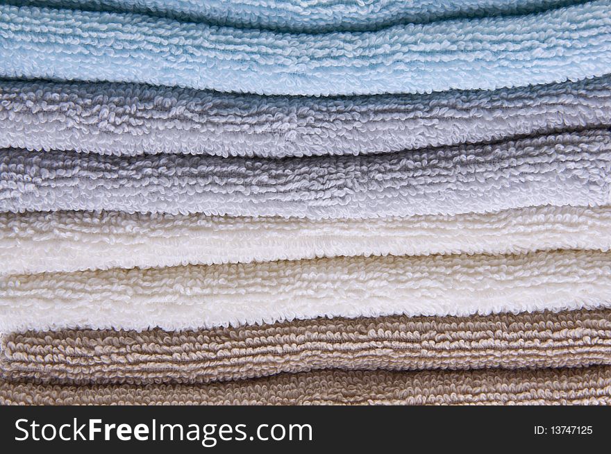 Neutral colored bath towels made of terry cloth.