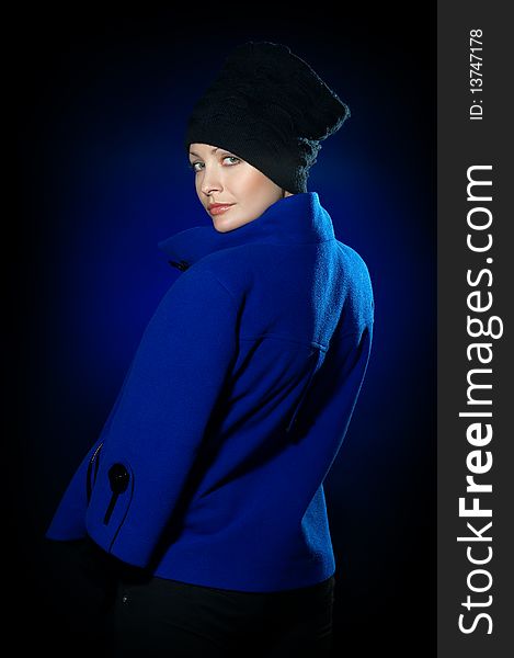 Young lady dressed in a blue topcoat and black hat. Young lady dressed in a blue topcoat and black hat