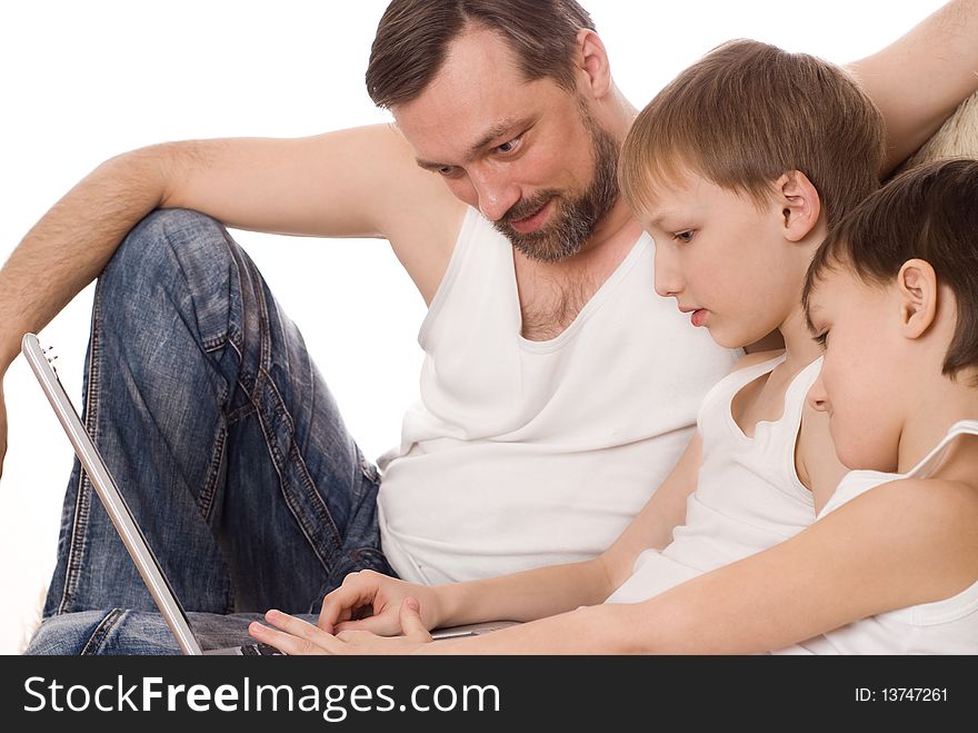 Young father with two sons with laptop