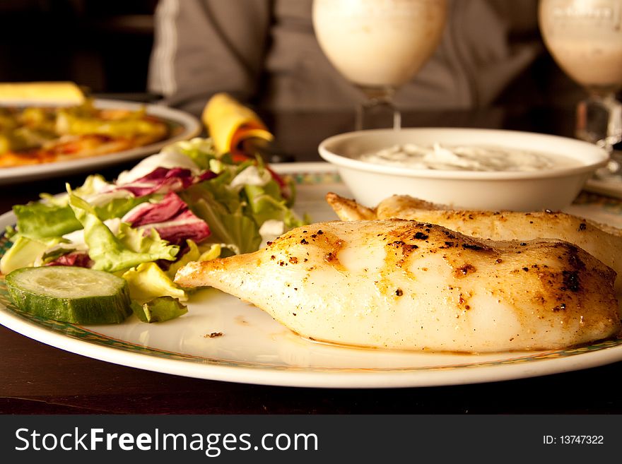 Fresh calamari served on a big plate. Fresh calamari served on a big plate