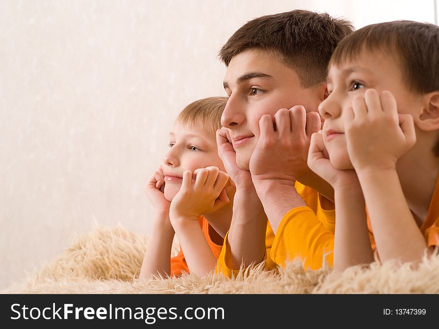 Three brothers in orange shirts