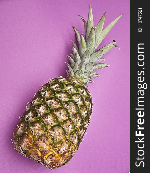 Pineapple on a vibrant purple colored background. Pineapple on a vibrant purple colored background