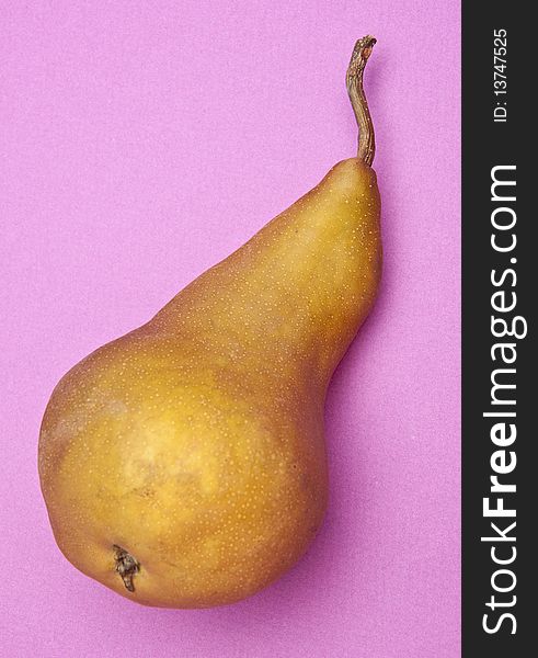 Pear on a vibrant purple colored background. Pear on a vibrant purple colored background