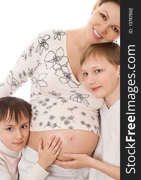 Pregnant woman standing with her two sons