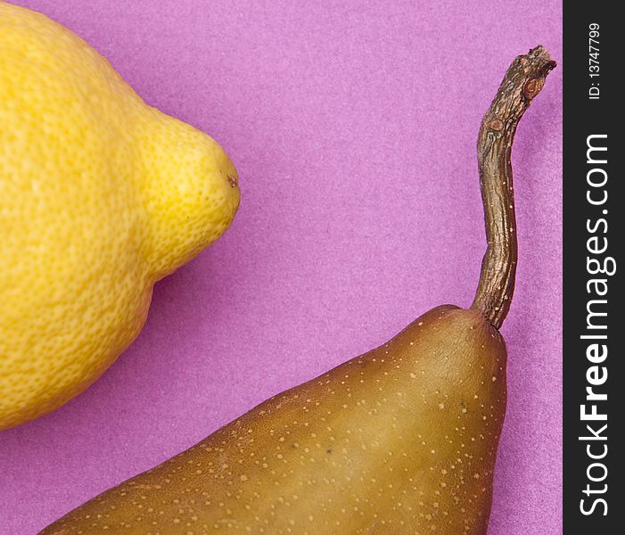 Lemon and Pear on a vibrant purple colored background. Lemon and Pear on a vibrant purple colored background