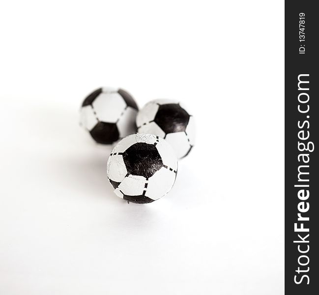 Three little footballs on a white background