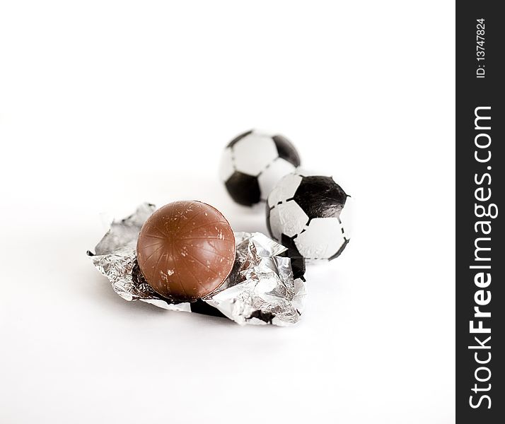 Little chocolate footballs on a white background