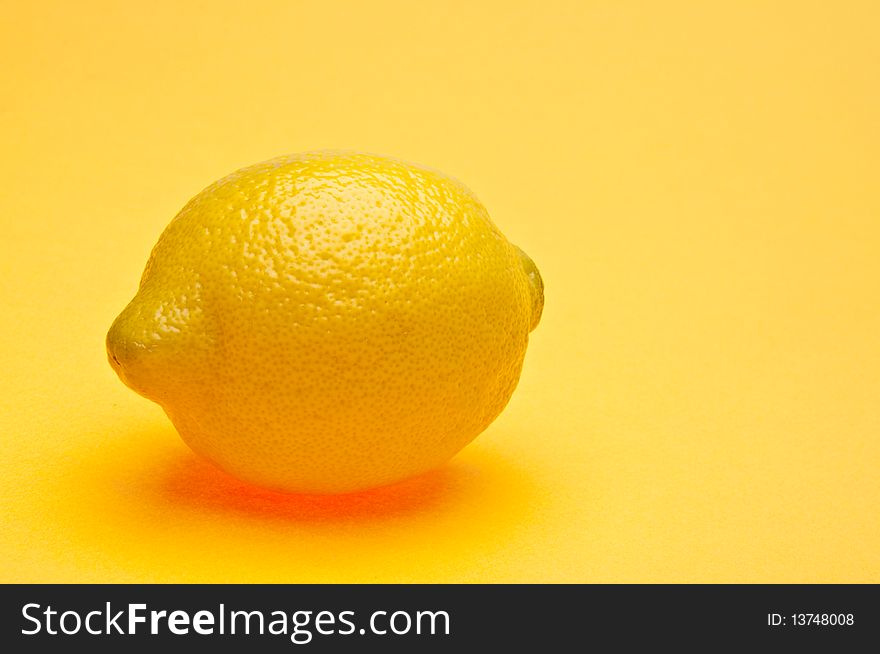 Lemon on a vibrant yellow background. Lemon on a vibrant yellow background.