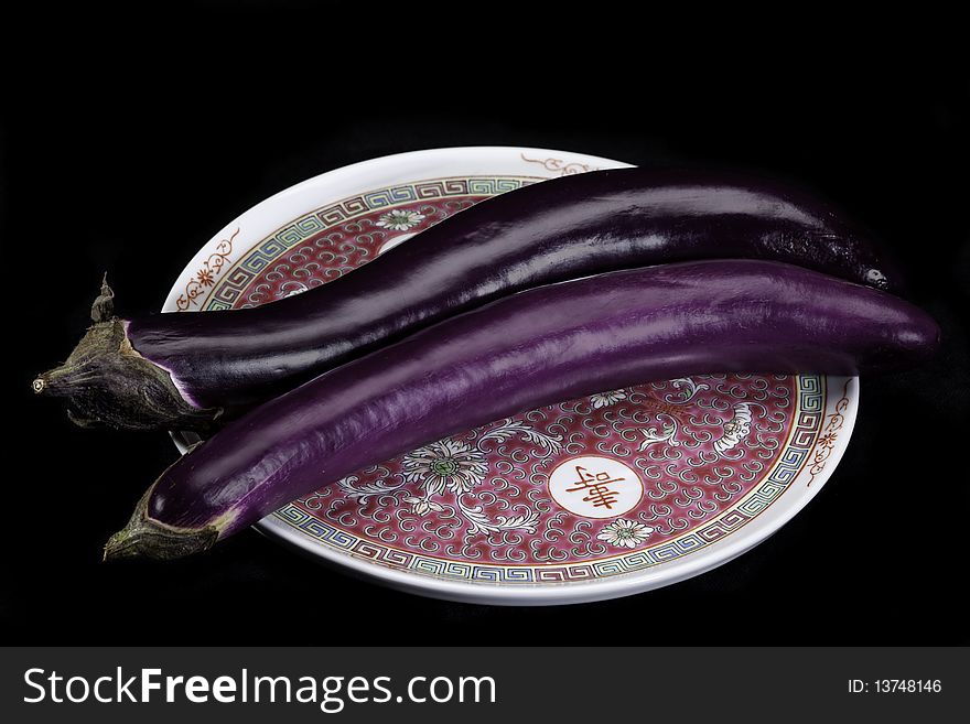 Chinese eggplants on Chinese pattern plate.