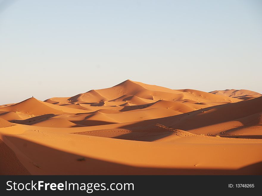 View of the dunes in the morocco desert at the sunrise