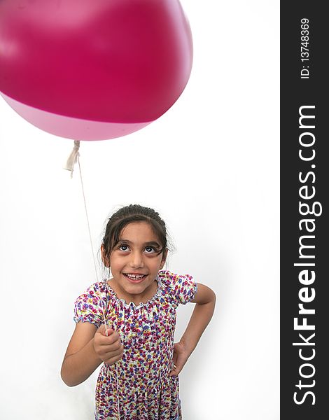 The little girl is happy with balloons in hand. The little girl is happy with balloons in hand