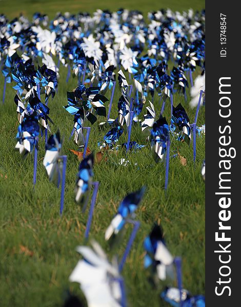 Blue and silver pinwheels blowing in the wind.