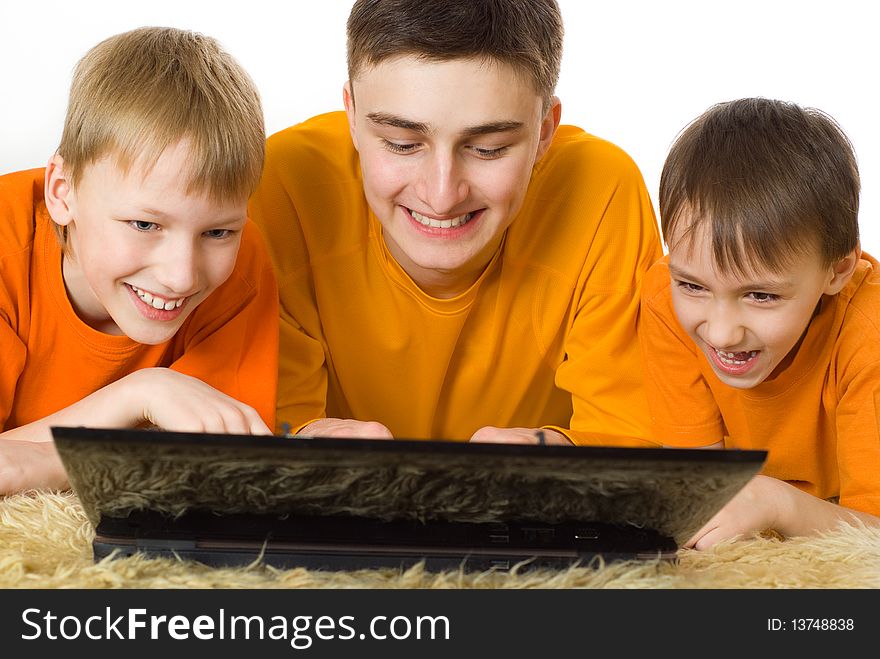 Three Brothers Looking At Laptop