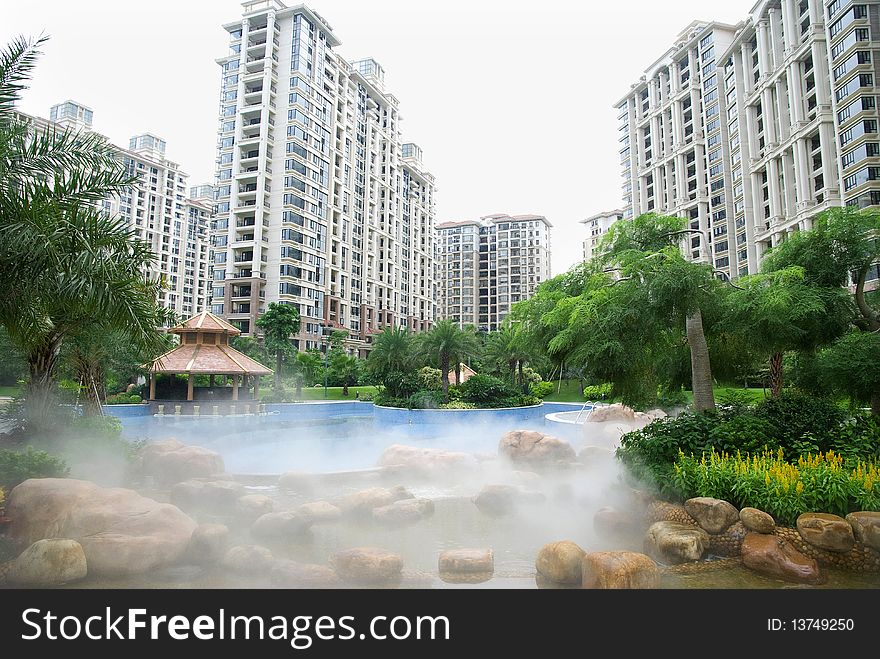 Exterior of the apartments house with swimming pool and beautiful garden.