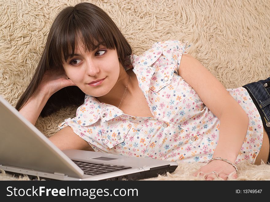 Beautiful young girl with a laptop on a white background. Beautiful young girl with a laptop on a white background