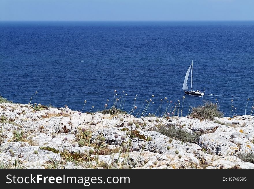 Lonely yacht sailing along Portugese Atlantic coast. Lonely yacht sailing along Portugese Atlantic coast