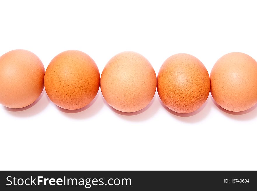 Row from brown eggs isolated on white background. Row from brown eggs isolated on white background