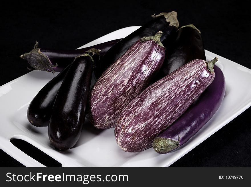 Eggplants arranged on a white dish. Eggplants arranged on a white dish.