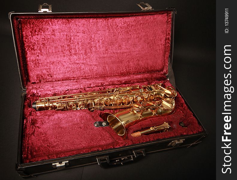 Golden saxophone in blabk case. Golden saxophone in blabk case