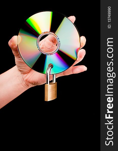 A hand holding a CD with a padlock on black background. A hand holding a CD with a padlock on black background