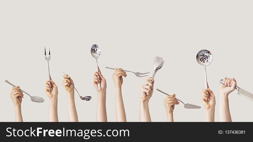 Hands holding kitchen equipment on isolated background hands and hold
