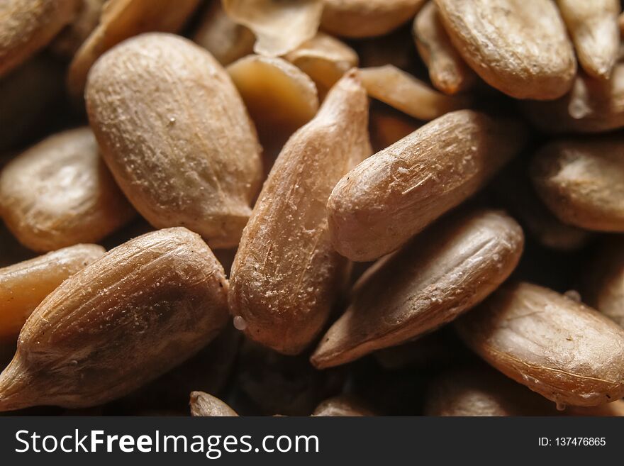 Peeled, roasted and salted sunflower seeds. Macro close-up photography.