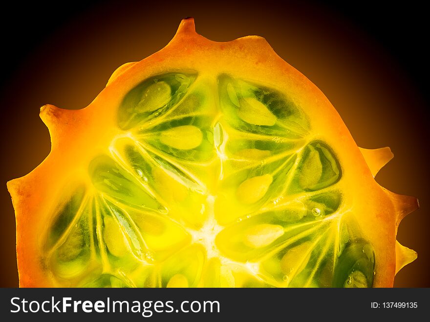 Kiwano Or Horned Melon Cucumis Metuliferus Sliced In A Half On Black Background