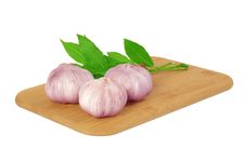 Garlic On The Board With A Bay Leaf. Stock Photos
