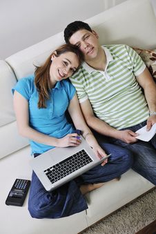 Young Couple Working On Laptop At Home Royalty Free Stock Images
