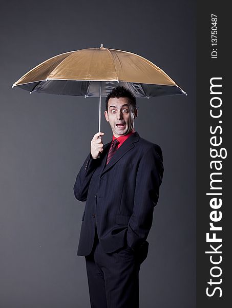 Young funny man with studio umbrella